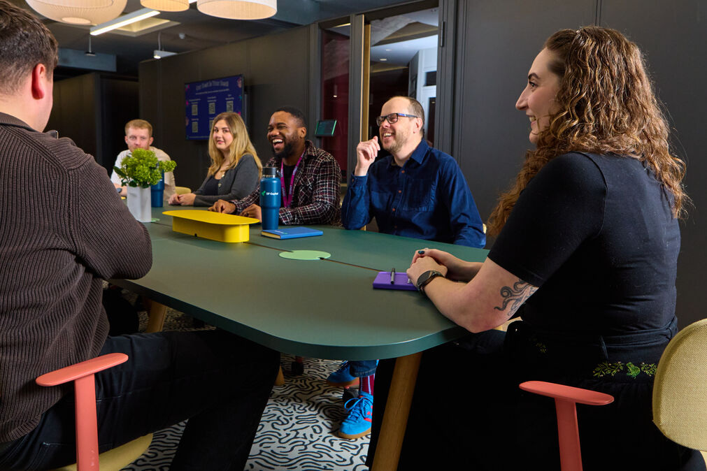 DF Capital staff discussing ideas in a meeting