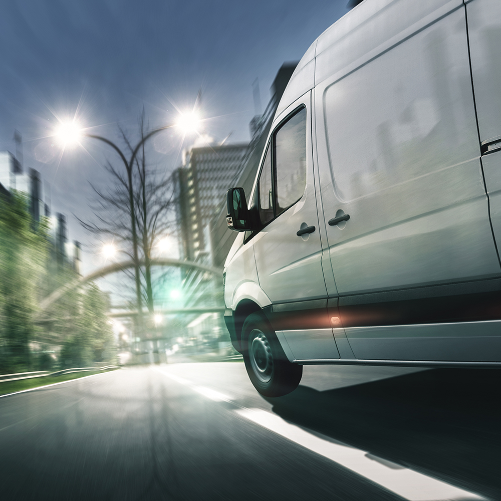 Delivery,van,drives,in,illuminated,city